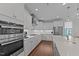 Contemporary kitchen with white cabinets, stainless steel appliances, and a stylish range hood at 2012 Sweet Samson St, Wake Forest, NC 27587