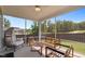 Covered outdoor patio with cushioned seating and views of the backyard at 2012 Sweet Samson St, Wake Forest, NC 27587