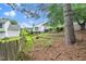 The backyard features a tiered garden, lawn, privacy fence, and a small deck area at 202 Homestead Park Dr, Apex, NC 27502