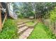 This backyard features multi-tiered terraced garden, privacy fence, and a wood deck at 202 Homestead Park Dr, Apex, NC 27502