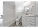 Clean bathroom features a shower-tub combo, a vanity with cabinet, and wood-look tile floors at 202 Homestead Park Dr, Apex, NC 27502