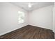 Neat bedroom boasts laminate floors, a ceiling fan, and a window for natural light at 202 Homestead Park Dr, Apex, NC 27502