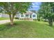 Charming single-story home with vibrant lawn, complemented by mature trees and inviting front porch at 202 Homestead Park Dr, Apex, NC 27502