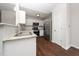 Modern kitchen with stainless appliances, white cabinets, granite counters and open concept design at 202 Homestead Park Dr, Apex, NC 27502