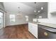 Modern kitchen featuring stainless appliances, granite countertops, and hardwood floors at 202 Homestead Park Dr, Apex, NC 27502