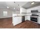 Modern eat-in kitchen with stainless appliances, white cabinets and view to the living area at 202 Homestead Park Dr, Apex, NC 27502