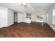 Open concept living room with hardwood floors flowing into dining, with access to a deck at 202 Homestead Park Dr, Apex, NC 27502