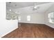 Spacious living area with hardwood floors, bright lighting, and abundant natural light from large windows at 202 Homestead Park Dr, Apex, NC 27502