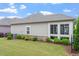 Well-maintained backyard with lush greenery, patio, and sunroom at 228 Ellisview Dr, Cary, NC 27519