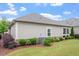 A beautifully landscaped backyard features lush lawn and attractive trees at 228 Ellisview Dr, Cary, NC 27519