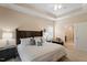 Bedroom with neutral decor, tray ceiling, and ensuite bathroom access at 228 Ellisview Dr, Cary, NC 27519