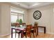 A cozy dining area featuring hardwood floors, a dark wood table, and a view to the patio area at 228 Ellisview Dr, Cary, NC 27519