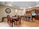 A cozy dining area featuring hardwood floors, a dark wood table, and a view to the kitchen area at 228 Ellisview Dr, Cary, NC 27519