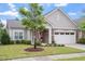 Charming home featuring stone accents, a covered porch, manicured lawn, and an attached two-car garage at 228 Ellisview Dr, Cary, NC 27519