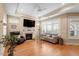 Comfortable living room with hardwood floors, a fireplace, ceiling fan, and an abundance of natural light at 228 Ellisview Dr, Cary, NC 27519
