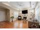 Spacious living room with hardwood floors, a fireplace, ceiling fan, and an abundance of natural light at 228 Ellisview Dr, Cary, NC 27519