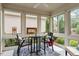 Bright sunroom with floor-to-ceiling windows, table and chairs overlooking nature at 228 Ellisview Dr, Cary, NC 27519