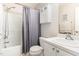 Neutral bathroom featuring a shower-tub combination and single sink vanity with an extra storage cabinet at 2301 Laurel Valley Way, Raleigh, NC 27604