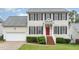 Two-story home featuring classic black shutters, a red front door, and a well-maintained lawn at 2301 Laurel Valley Way, Raleigh, NC 27604