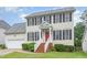 Charming two-story home featuring classic black shutters, a red front door, and a well-maintained lawn at 2301 Laurel Valley Way, Raleigh, NC 27604