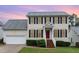 Charming two-story home with a red front door, a two-car garage, and manicured landscaping at 2301 Laurel Valley Way, Raleigh, NC 27604