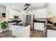 Bright kitchen with stainless steel appliances, a center island, and sleek white cabinets at 2301 Laurel Valley Way, Raleigh, NC 27604