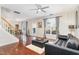 Inviting living room with hardwood floors, a black leather sofa, and ample natural light at 2301 Laurel Valley Way, Raleigh, NC 27604