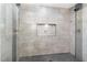 Walk-in shower featuring gray tile and glass door at 2301 Laurel Valley Way, Raleigh, NC 27604