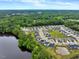 Aerial view of a community by the lake with homes, landscaping, and ponds at 2426 Heron Watch Pl, Fuquay Varina, NC 27526