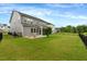 Large backyard features a patio with seating and a fenced-in lawn at 2426 Heron Watch Pl, Fuquay Varina, NC 27526