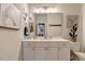 Elegant bathroom featuring white vanity, decorated with art and a cactus at 2426 Heron Watch Pl, Fuquay Varina, NC 27526