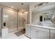 Modern bathroom with a glass-enclosed shower, marble tiling, and sleek fixtures for a spa-like experience at 2426 Heron Watch Pl, Fuquay Varina, NC 27526