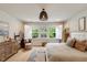 Inviting bedroom filled with natural light from large windows, complemented by chic decor and a cozy ambiance at 2426 Heron Watch Pl, Fuquay Varina, NC 27526