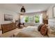 Bright bedroom featuring large windows with shutters, a comfortable bed, and stylish furnishings at 2426 Heron Watch Pl, Fuquay Varina, NC 27526