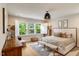 Cozy bedroom featuring a comfortable bed, large window with white shutters, and stylish rustic decor at 2426 Heron Watch Pl, Fuquay Varina, NC 27526