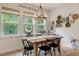 Charming dining room with a wood table, chandelier, and large windows offering plenty of natural light at 2426 Heron Watch Pl, Fuquay Varina, NC 27526