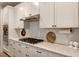 Well-appointed kitchen with white cabinetry, granite countertops, and modern fixtures at 2426 Heron Watch Pl, Fuquay Varina, NC 27526