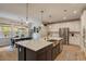 Open kitchen with large island, stainless steel appliances, and adjacent dining area at 2426 Heron Watch Pl, Fuquay Varina, NC 27526