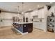 Bright kitchen with island seating, white cabinets, and modern appliances at 2426 Heron Watch Pl, Fuquay Varina, NC 27526