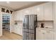 Modern kitchen features stainless steel appliances, white cabinets, and a spacious pantry with the word 