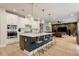 Modern kitchen with large island, pendant lighting, and stainless steel appliances at 2426 Heron Watch Pl, Fuquay Varina, NC 27526
