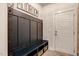 Stylish mudroom with built-in bench, storage cubbies, and hooks for organization and convenience at 2426 Heron Watch Pl, Fuquay Varina, NC 27526