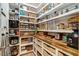 Organized walk-in pantry with custom wood countertop, drawers, shelving, and bins for storage and convenience at 2426 Heron Watch Pl, Fuquay Varina, NC 27526