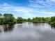 Beautiful view of a calm pond and lush green trees, perfect for nature lovers at 2426 Heron Watch Pl, Fuquay Varina, NC 27526