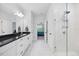 Bathroom with double vanity, black countertop, white cabinets, and walk-in glass shower at 247 Axis Deer Ln, Garner, NC 27529