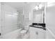Clean bathroom featuring a shower-tub combo, toilet, and sink with modern fixtures at 247 Axis Deer Ln, Garner, NC 27529
