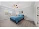 Cozy bedroom with plush carpet, ceiling fan, and large window offering natural light at 247 Axis Deer Ln, Garner, NC 27529