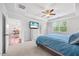 Comfortable bedroom featuring a ceiling fan, large windows, and a view into the dining area at 247 Axis Deer Ln, Garner, NC 27529