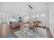 Open-concept dining area with natural light, stylish decor, and hardwood floors at 247 Axis Deer Ln, Garner, NC 27529