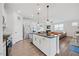 Spacious kitchen featuring an island with sink, stainless steel appliances, and open layout to the living area at 247 Axis Deer Ln, Garner, NC 27529